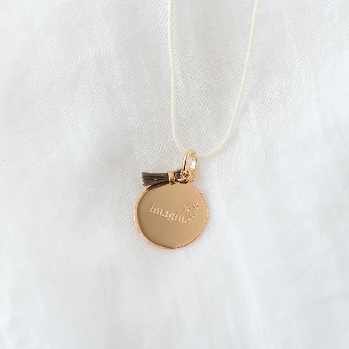 Collier petite médaille et pompon sur lien coton plaqué or