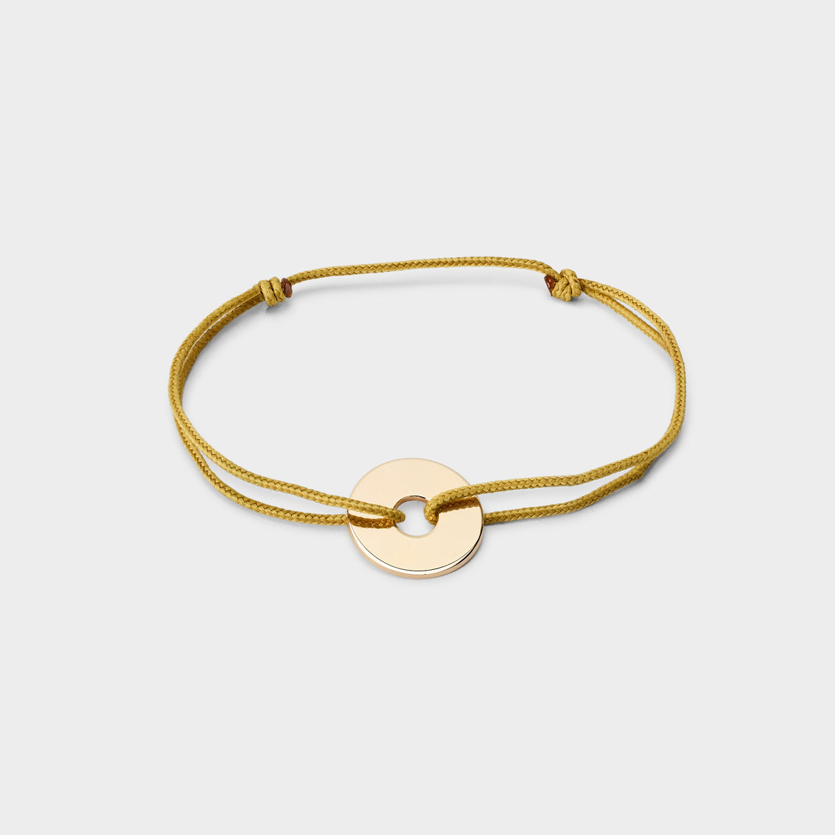 Bracelet petite cible plaqué or sur lien coton