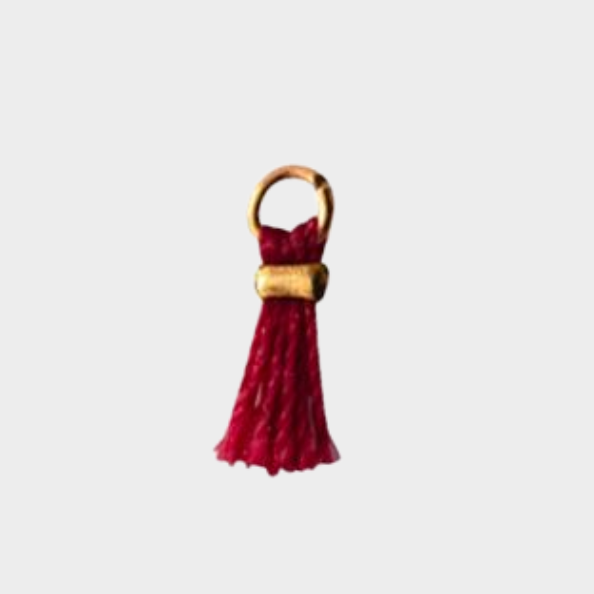 Mini pompon plaqué or bordeaux