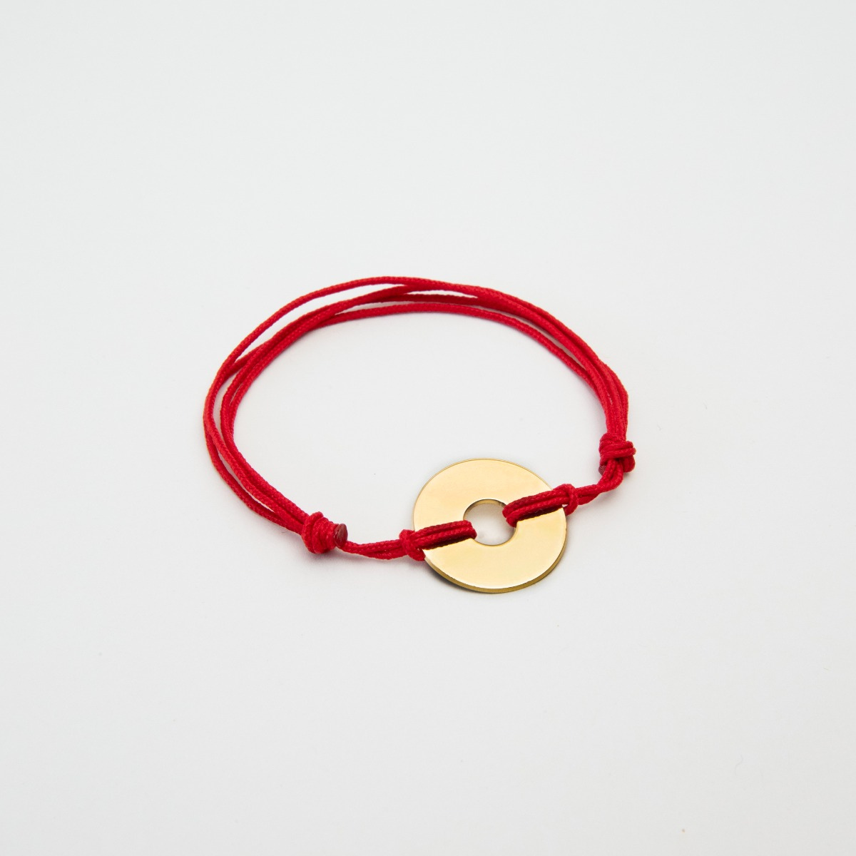 Bracelet petite cible plaqué or sur lien coton
